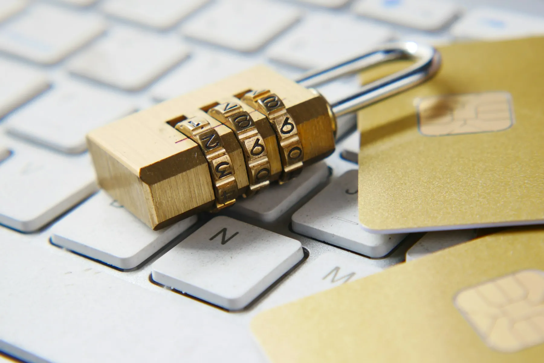 Combination padlock resting on a laptop keyboard