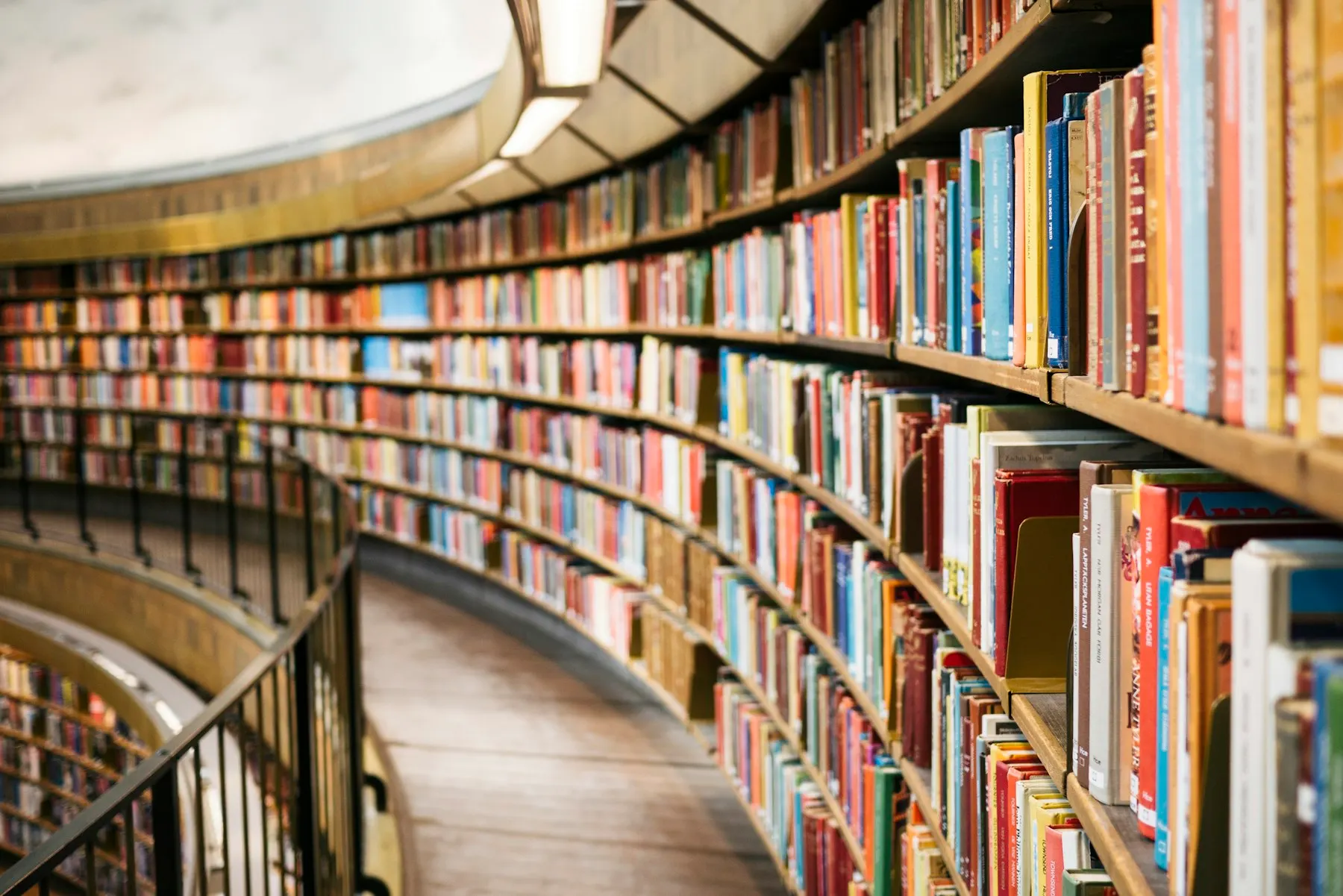 Curved shelves of books in a library