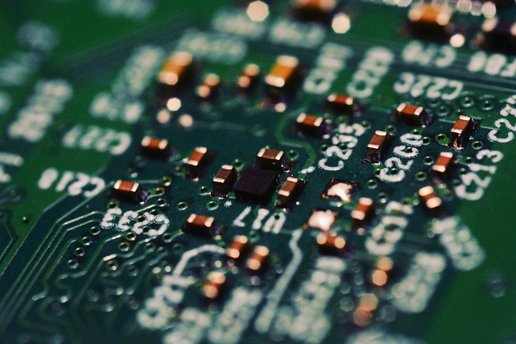 Close-up of electronic components on a green circuit board